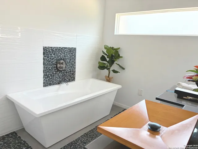 a white bath tub sitting in a bathroom