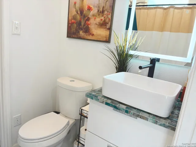 a white toilet sitting next to a bathroom sink