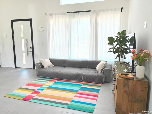 a living room with furniture and a potted plant
