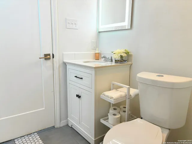 a white toilet sitting next to a bathroom sink