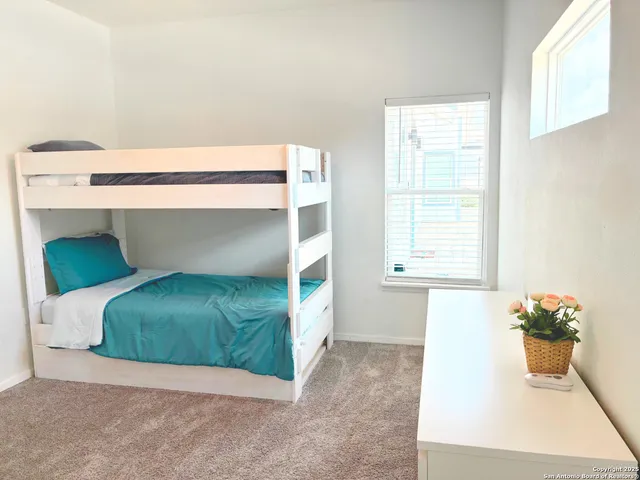 a living room with a bed and a window