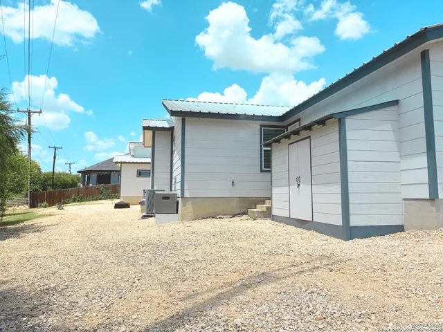 a view of a house with a snow in the yard