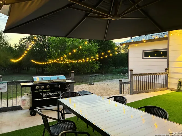 a view of a patio with a table chairs and a umbrella