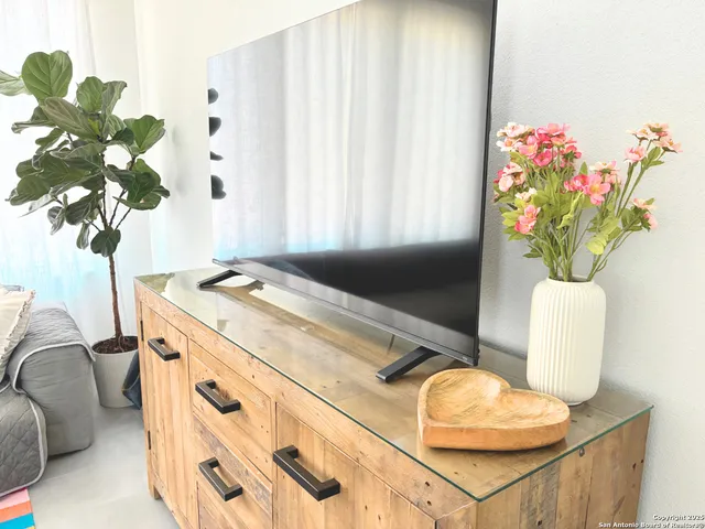 a bathroom with a sink a potted plant and a window