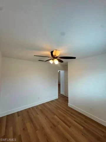 a view of an empty room and wooden floor