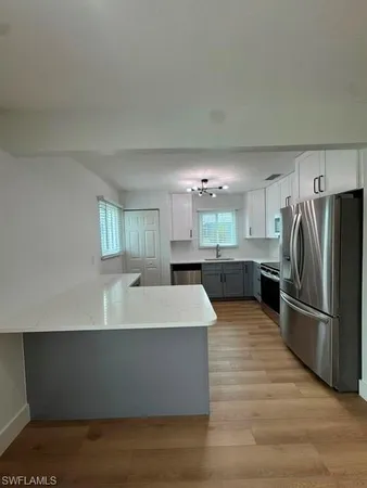 a large kitchen with kitchen island a sink dishwasher a refrigerator and a stove