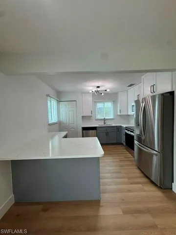 a large kitchen with kitchen island a sink dishwasher a refrigerator and a stove