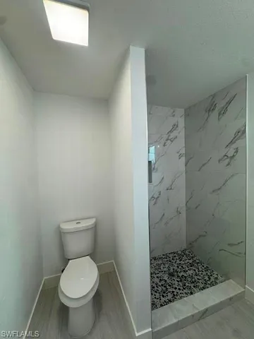 a bathroom with a toilet and a shower