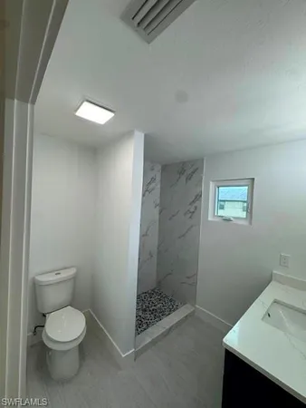 a bathroom with a toilet sink and shower