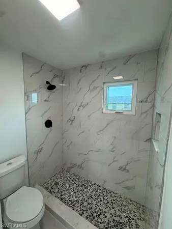 a bathroom with a toilet and shower