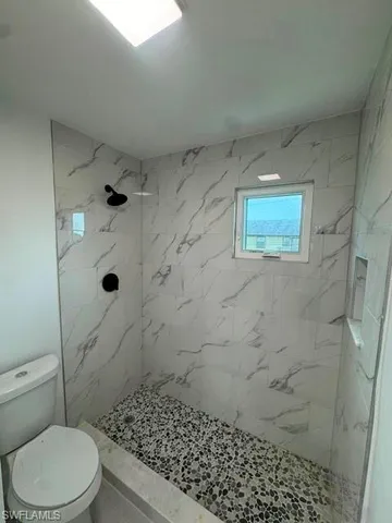 a bathroom with a toilet and shower