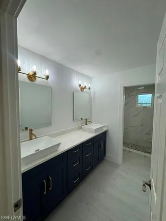 a bathroom with a double vanity sink and mirror