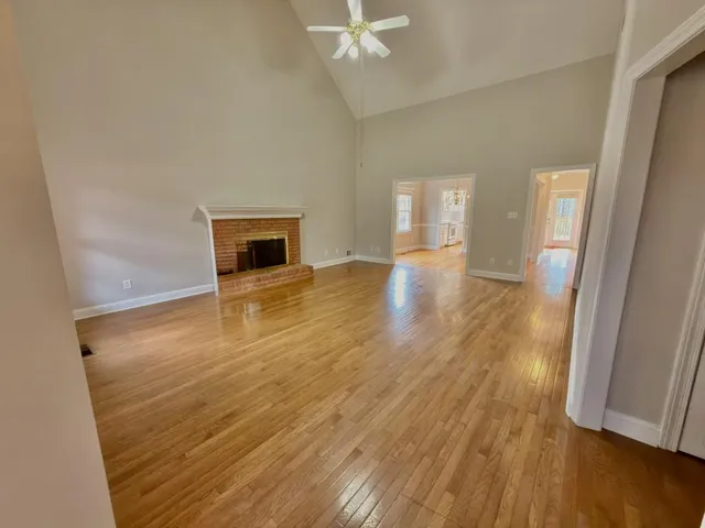 wooden floor in an empty room with a fireplace