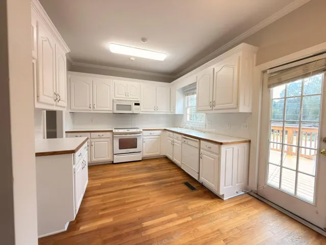 a large kitchen with stainless steel appliances granite countertop a stove a sink dishwasher and a refrigerator