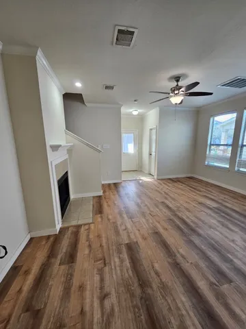wooden floor in an empty room with a fireplace