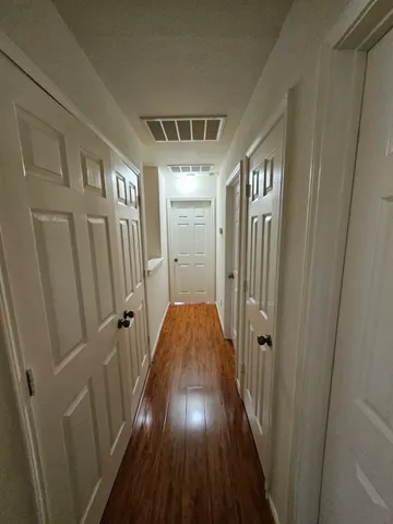 a view of hallway with wooden floor