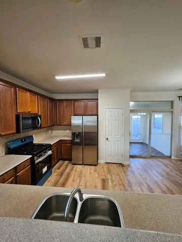 a kitchen with granite countertop a sink and a stove top oven