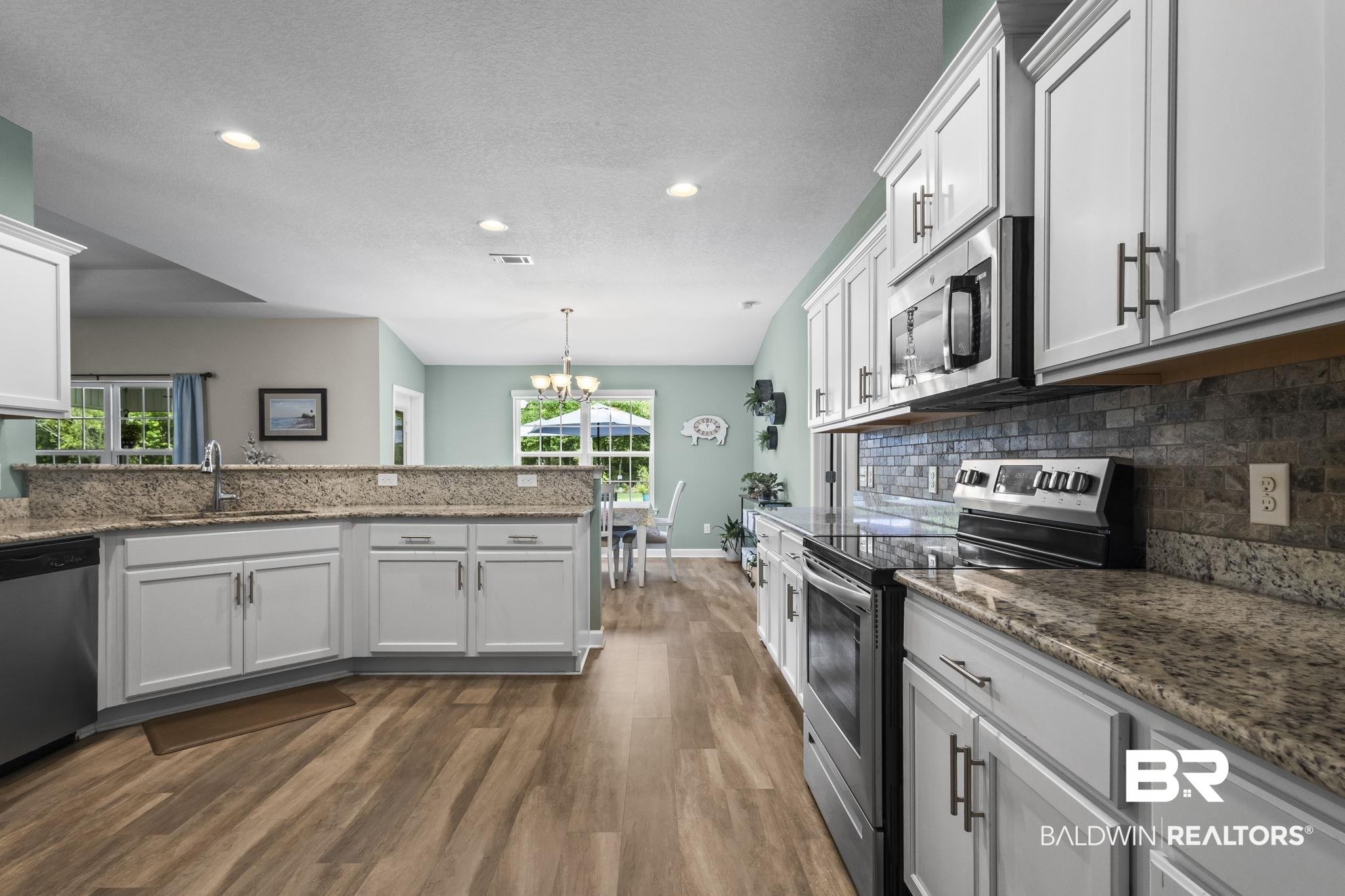 10473 Lyttleton Loop Lillian, AL 36549 - Photo 34 of 57 Kitchen with appliances with stainless steel finishes, dark wood-style floors, plenty of natural light, recessed lighting, and a chandelier