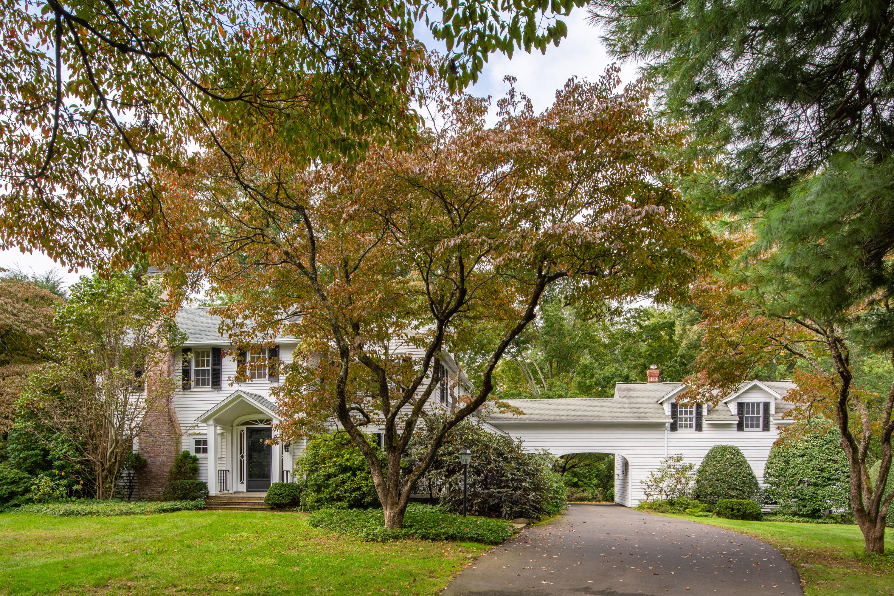 275 Hollow Tree Ridge Road Darien, CT 06820 - Photo 6 of 41 a front view of a house with a yard and garage