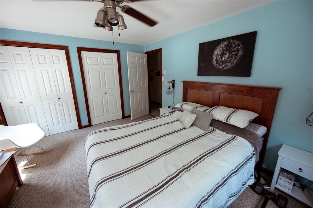 1124 Bemis Road, Unit A Warren, MA 01585 - Photo 18 of 33 a bedroom with a bed and a chandelier