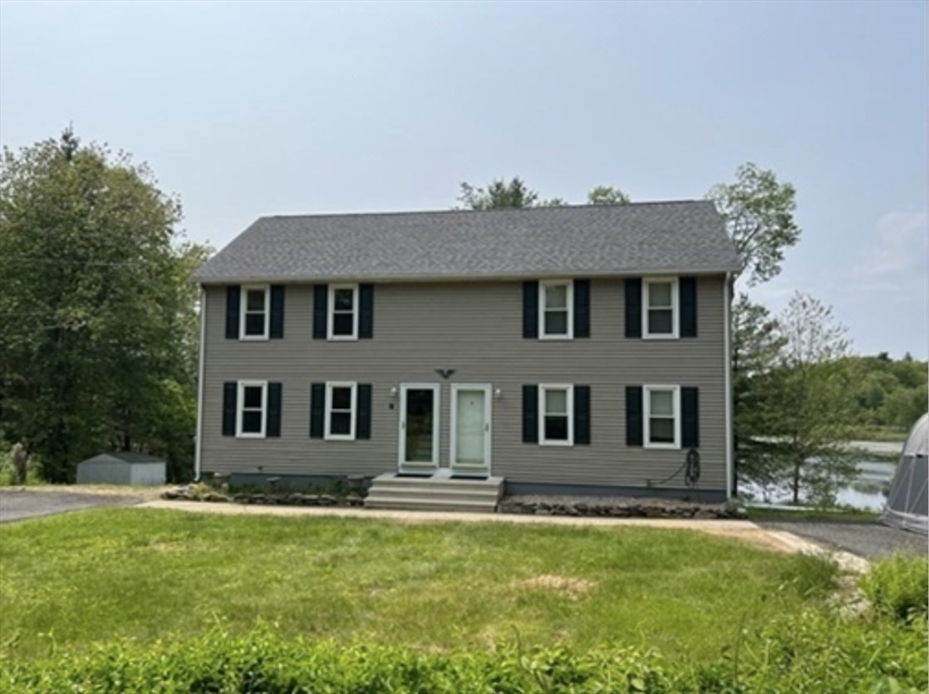 1124 Bemis Road, Unit A Warren, MA 01585 - Photo 4 of 33 a front view of a house with a yard