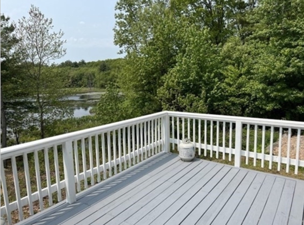 1124 Bemis Road, Unit A Warren, MA 01585 - Photo 7 of 33 a balcony with wooden floor and fence
