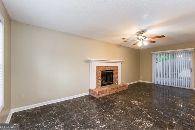 an empty room with fan and windows