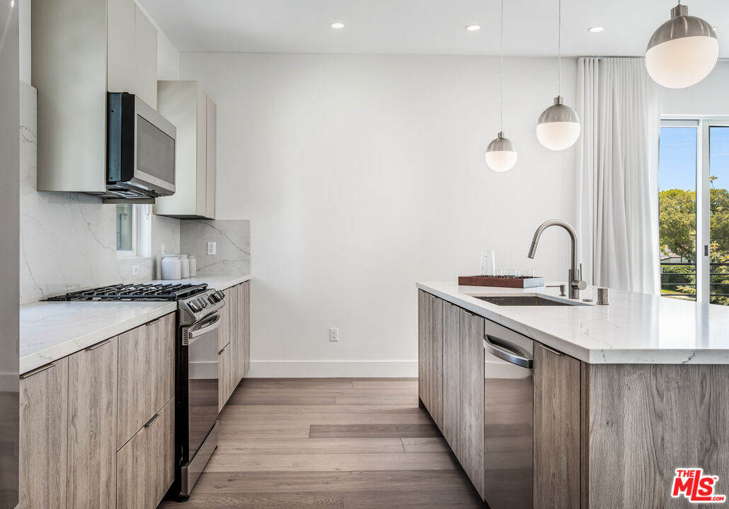 1573 Hi Point Street Los Angeles, CA 90035 - Photo 15 of 56 a kitchen with a sink stove and microwave