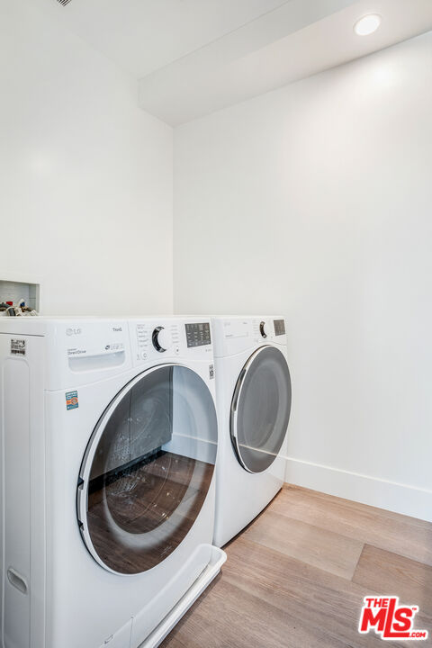 1573 Hi Point Street Los Angeles, CA 90035 - Photo 18 of 56 a utility room with dryer and washer