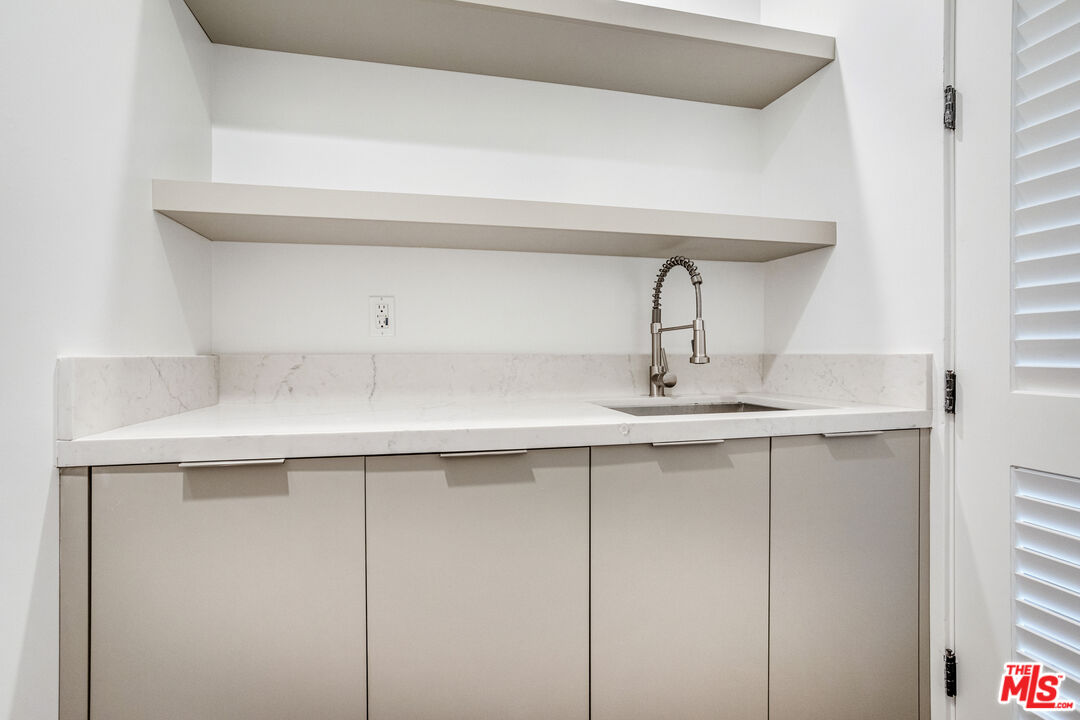 1573 Hi Point Street Los Angeles, CA 90035 - Photo 19 of 56 a bathroom with a sink and a mirror