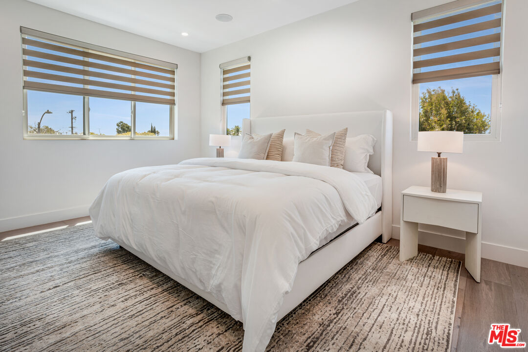 1573 Hi Point Street Los Angeles, CA 90035 - Photo 21 of 56 a bedroom with a bed and wooden floor