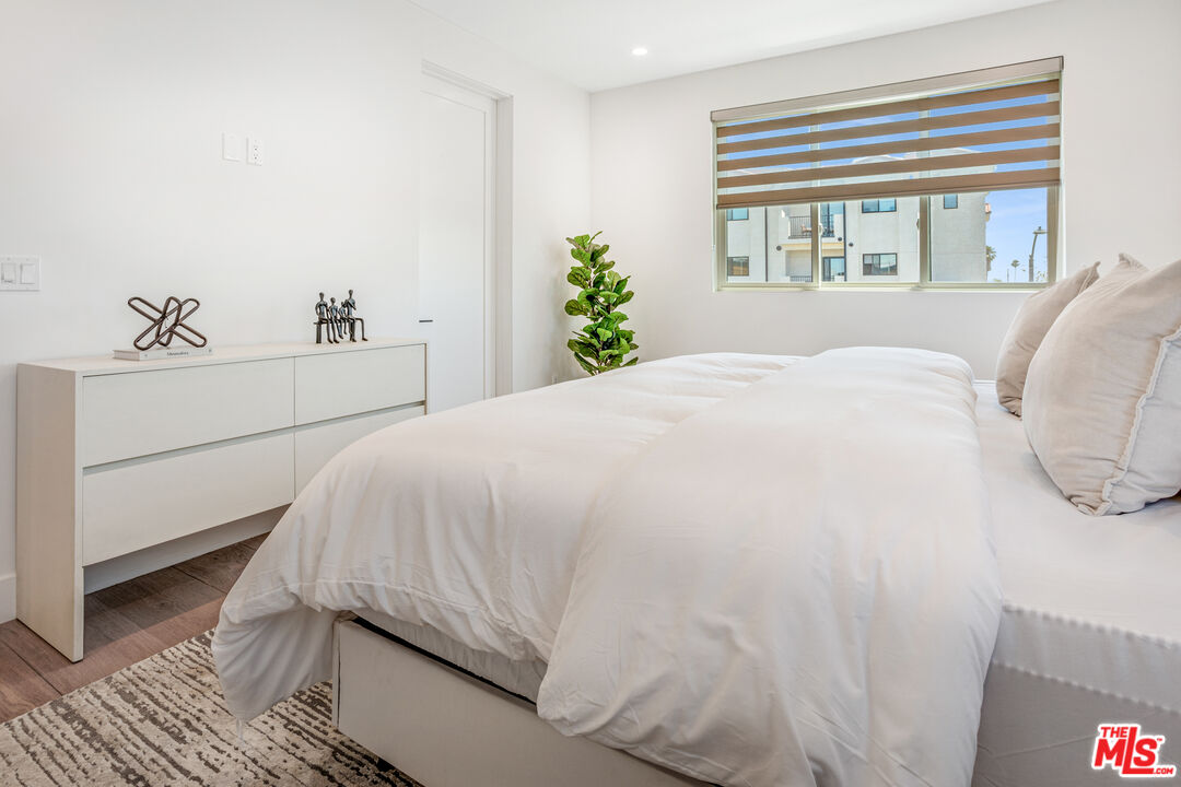 1573 Hi Point Street Los Angeles, CA 90035 - Photo 22 of 56 a bedroom with a bed and a window