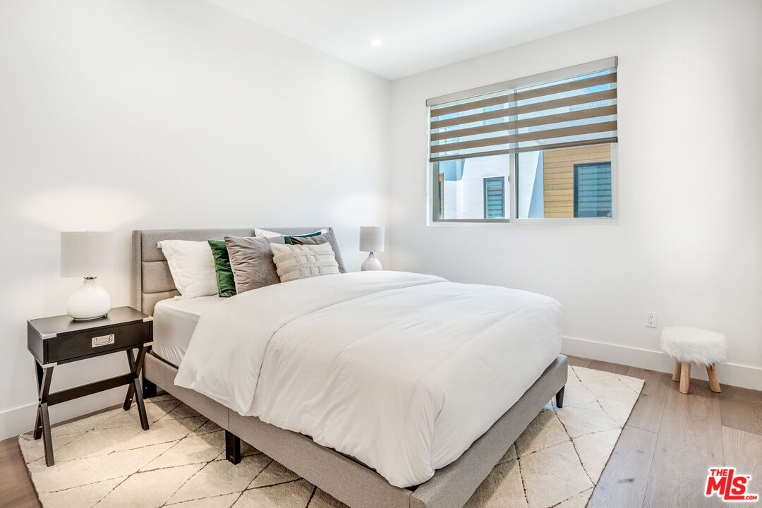 1573 Hi Point Street Los Angeles, CA 90035 - Photo 28 of 56 a bedroom with a bed and a night stand