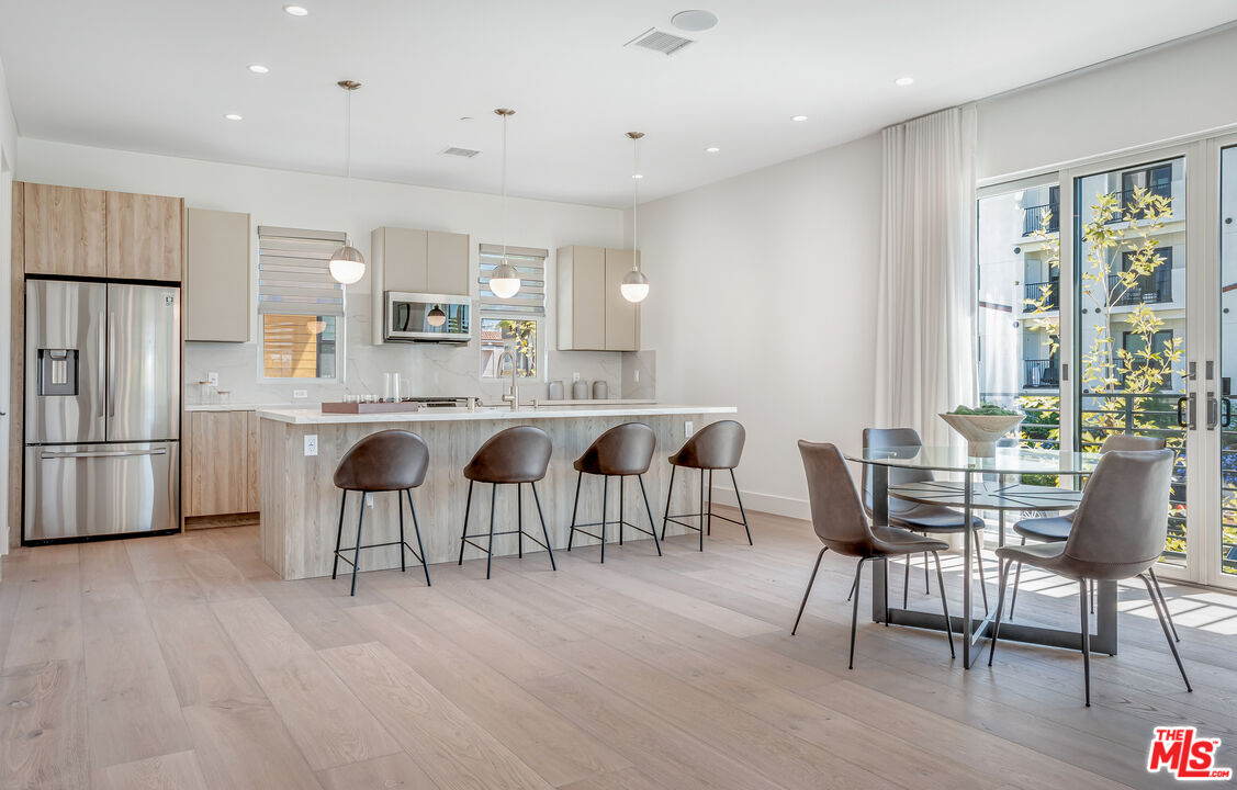 1573 Hi Point Street Los Angeles, CA 90035 - Photo 3 of 56 a large kitchen with a table and chairs