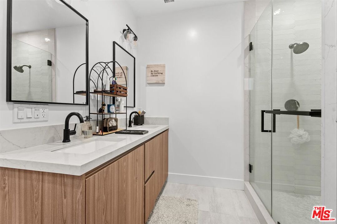 1573 Hi Point Street Los Angeles, CA 90035 - Photo 38 of 56 a bathroom with a sink and a mirror