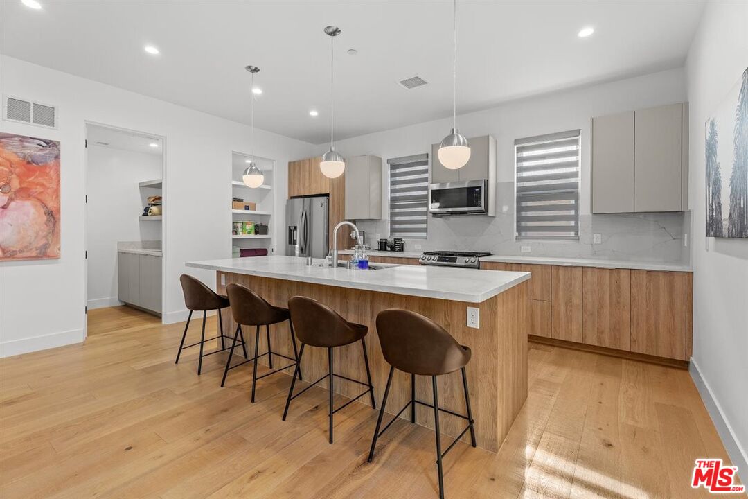 1573 Hi Point Street Los Angeles, CA 90035 - Photo 39 of 56 a kitchen with a table and chairs in it