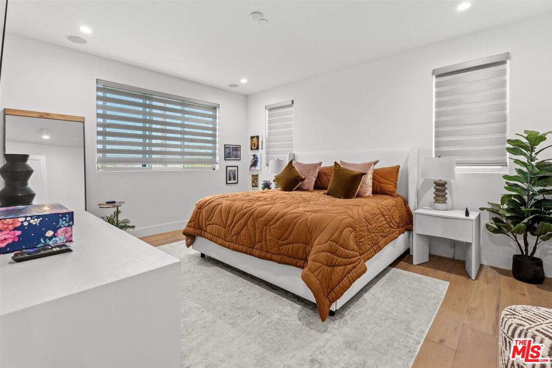 1573 Hi Point Street Los Angeles, CA 90035 - Photo 40 of 56 a bedroom with a bed window and potted plant