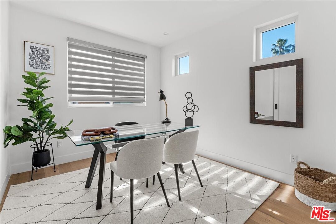 1573 Hi Point Street Los Angeles, CA 90035 - Photo 42 of 56 a view of a dining room with furniture and a potted plant