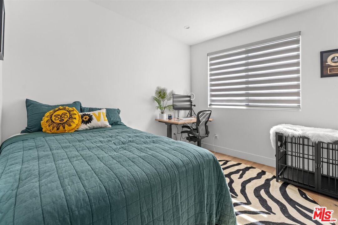 1573 Hi Point Street Los Angeles, CA 90035 - Photo 45 of 56 a bedroom with a bed and wooden floor