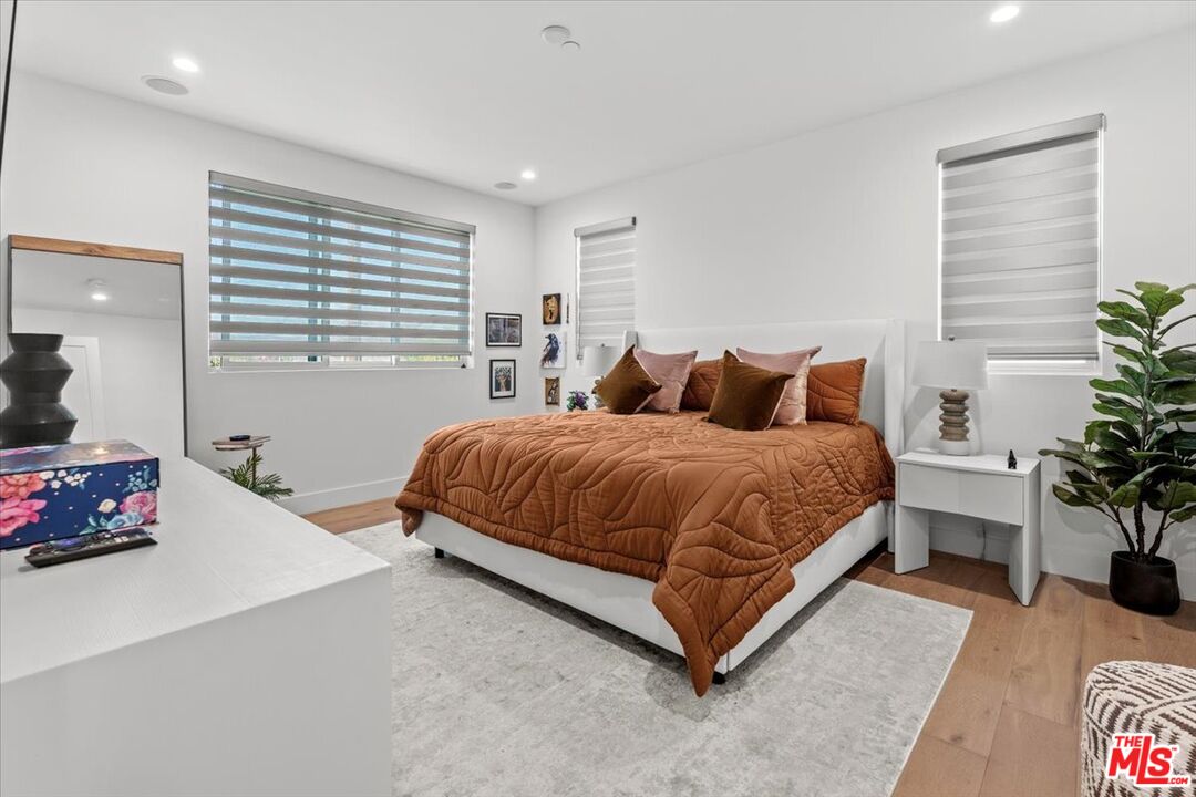 1573 Hi Point Street Los Angeles, CA 90035 - Photo 6 of 56 a bedroom with a bed window and potted plant