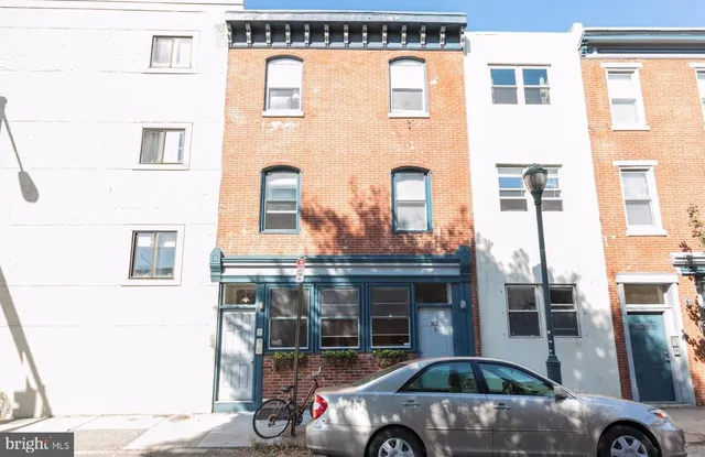 a front view of a building with parking space