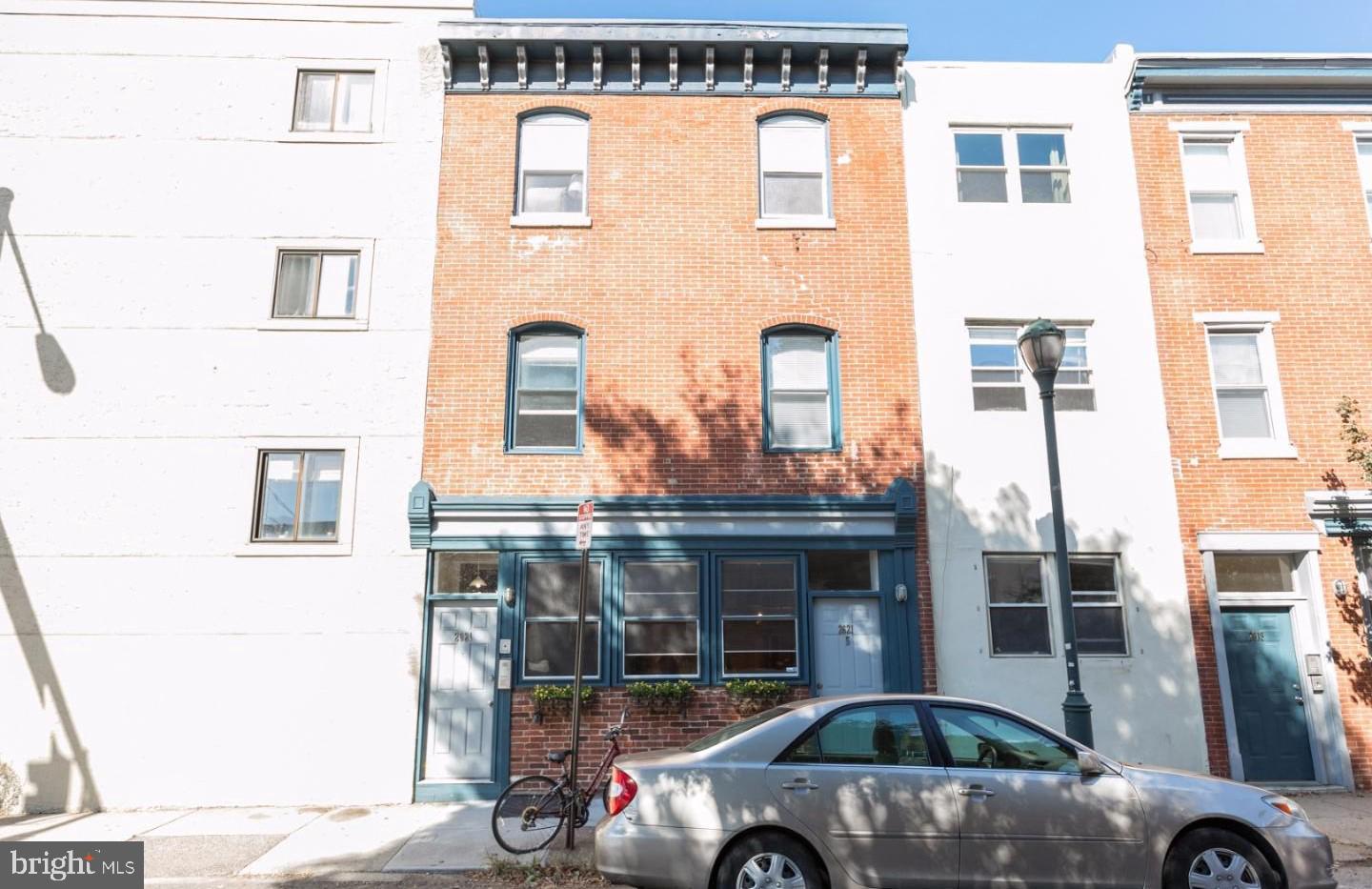 a front view of a building with parking space