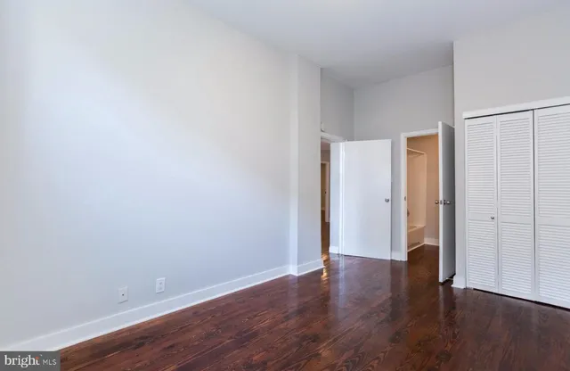 a view of an empty room with wooden floor