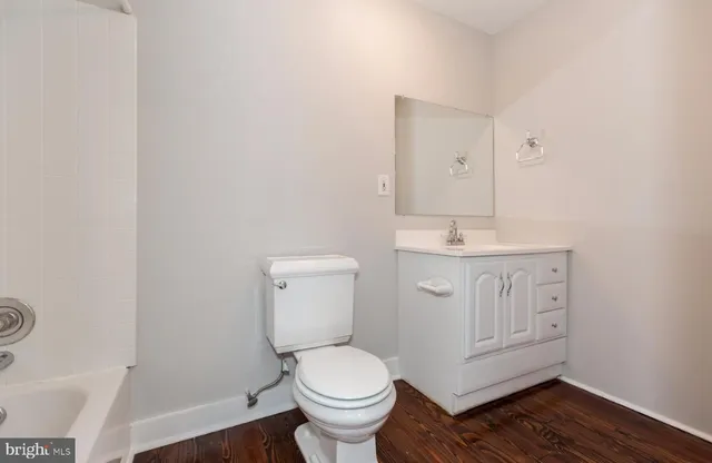 a bathroom with a toilet sink and a mirror