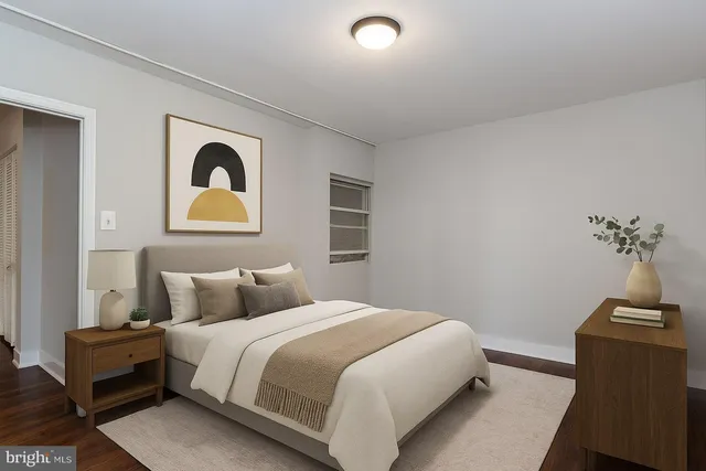 a bedroom with a bed and painting on the wall