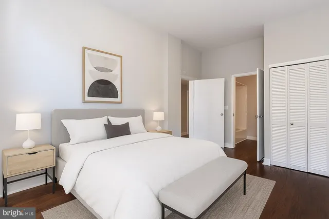 a bedroom with a bed and a lamp