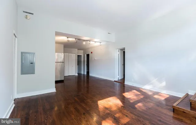 a view of a hallway with wooden floor