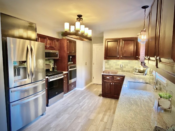 7404 Hoods Branch Road Springfield, TN 37172 - Photo 22 of 50 a large kitchen with a refrigerator stove and sink