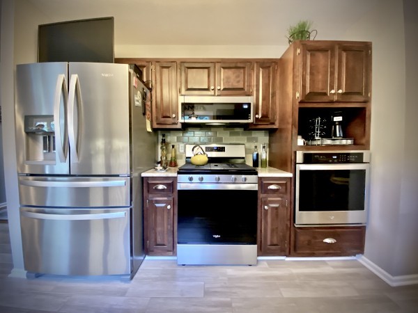7404 Hoods Branch Road Springfield, TN 37172 - Photo 23 of 50 a kitchen with granite countertop a refrigerator stove and microwave