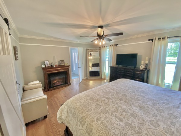 7404 Hoods Branch Road Springfield, TN 37172 - Photo 25 of 50 a bedroom with a bed and a fireplace